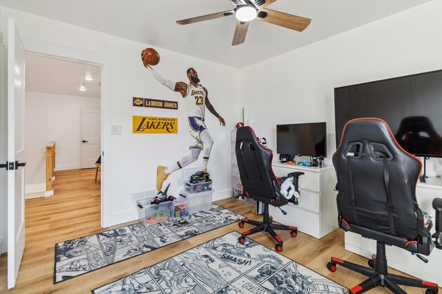 home office with hardwood / wood-style flooring and ceiling fan