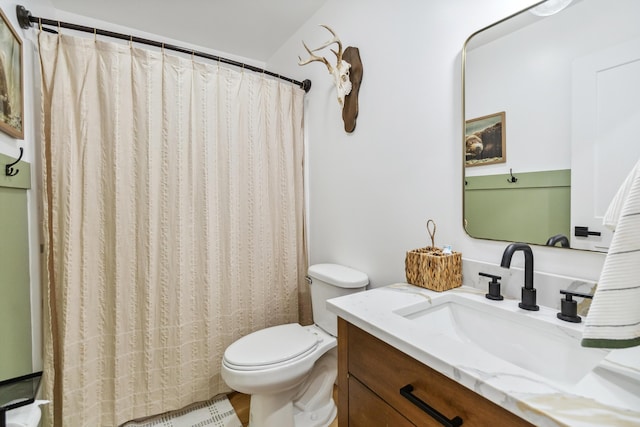 bathroom with vanity, toilet, and walk in shower