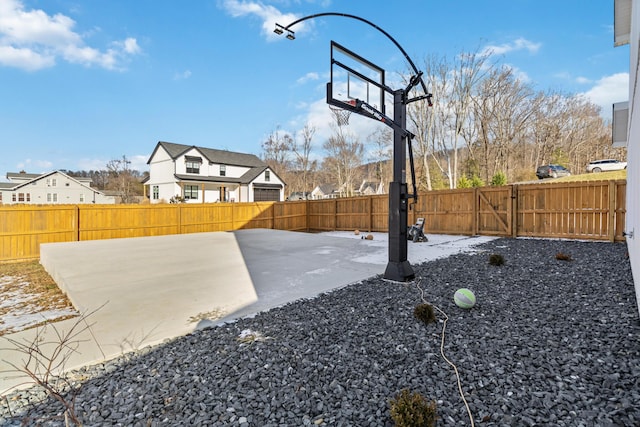 view of yard featuring a patio and basketball hoop