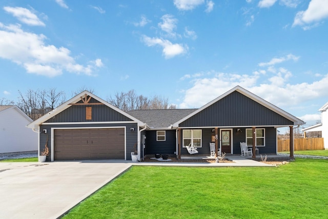 view of front facade with a garage, a front yard, and covered porch