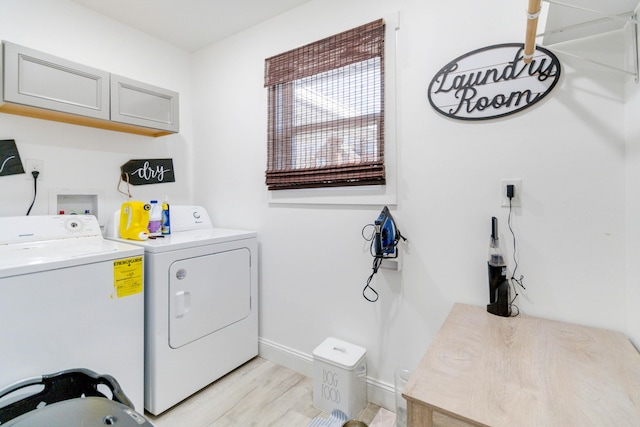 clothes washing area featuring washer and dryer and light wood-type flooring