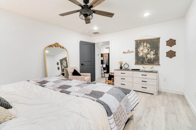 bedroom with ceiling fan and light hardwood / wood-style flooring