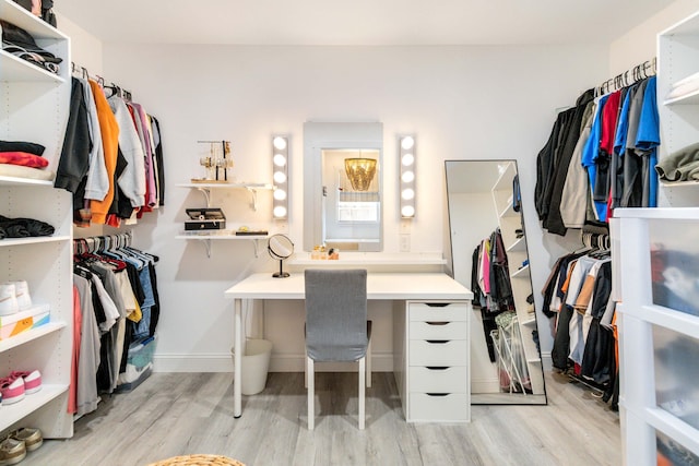 walk in closet with light wood-type flooring