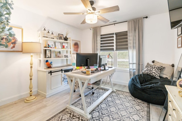 office space with light hardwood / wood-style flooring and ceiling fan