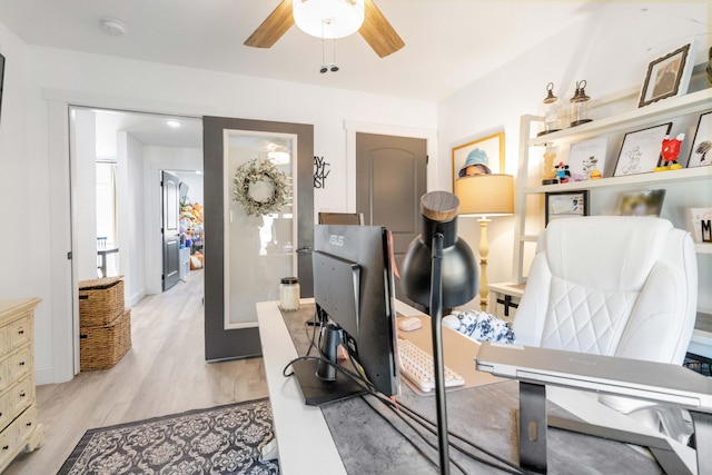 home office featuring ceiling fan and light hardwood / wood-style flooring