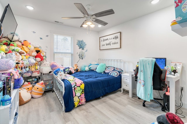 bedroom with ceiling fan and light wood-type flooring