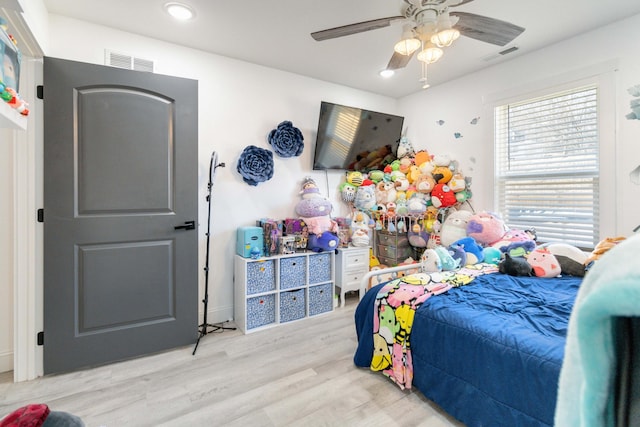 bedroom featuring light hardwood / wood-style flooring and ceiling fan