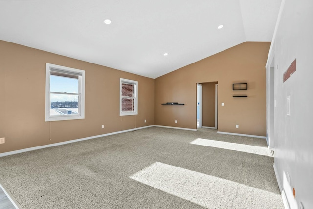 unfurnished room with lofted ceiling and light colored carpet