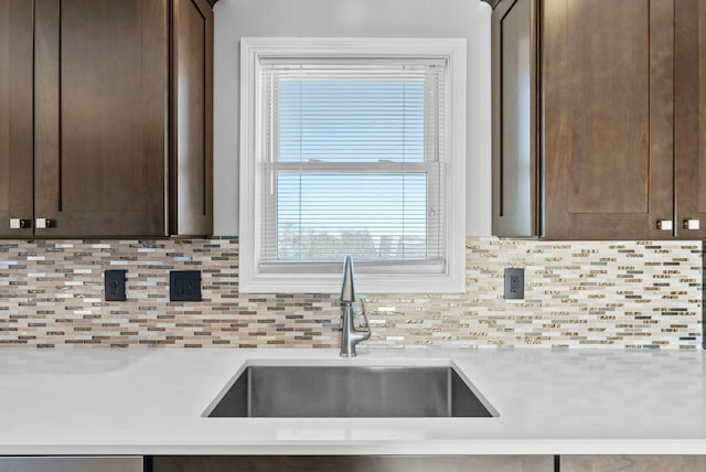 kitchen with sink, decorative backsplash, and dark brown cabinets