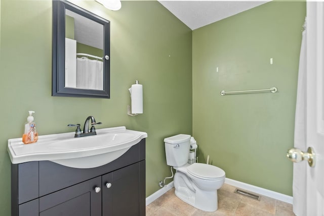 bathroom with vanity, tile patterned floors, and toilet