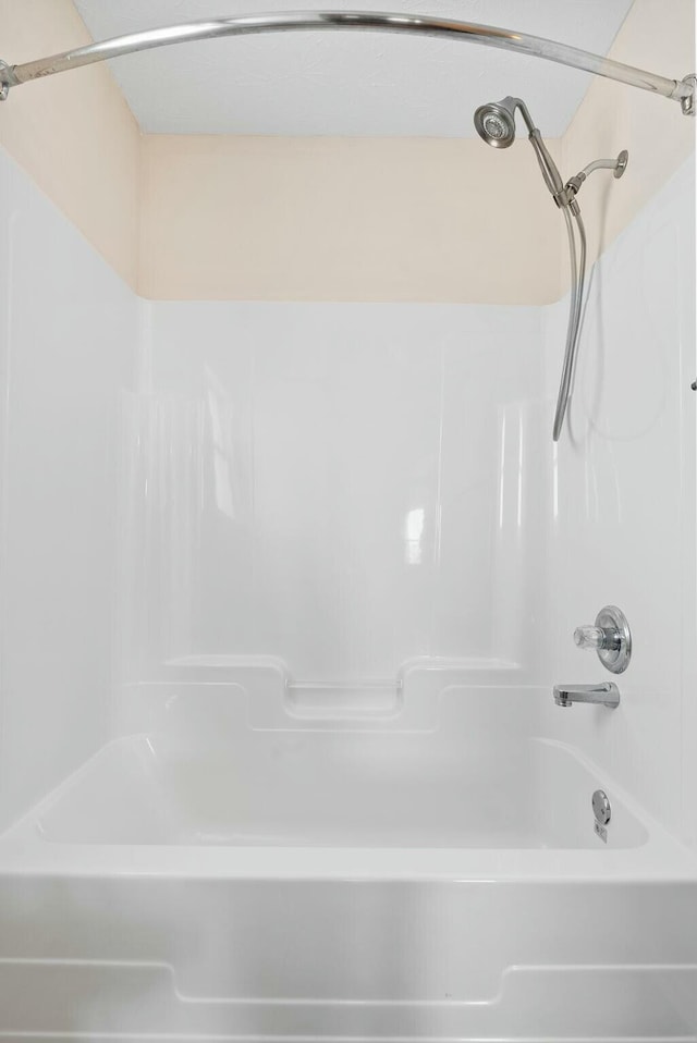 bathroom with washtub / shower combination