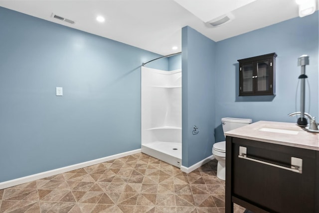 bathroom with vanity, toilet, and a shower