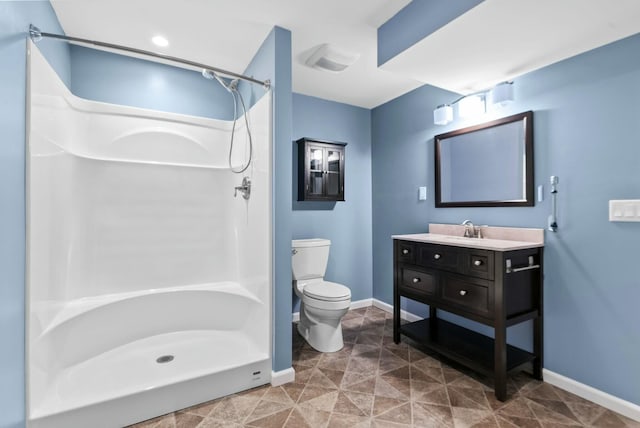 bathroom with a shower, vanity, and toilet