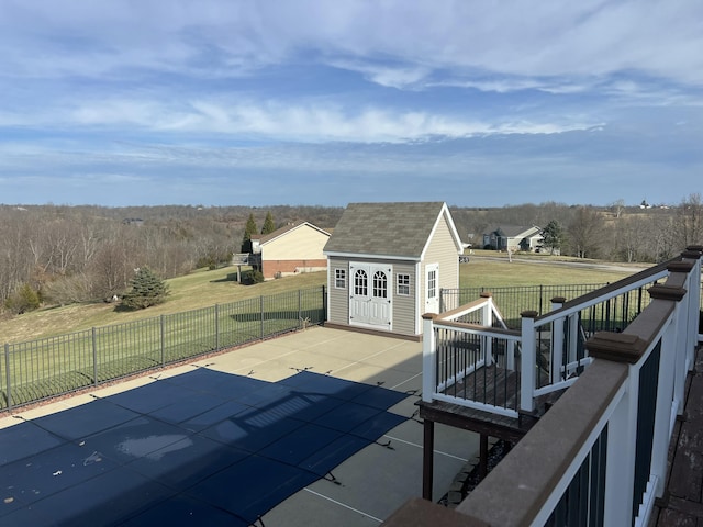 view of swimming pool featuring an outdoor structure, a yard, and a patio area