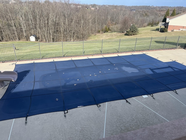 view of swimming pool with a yard and a water slide