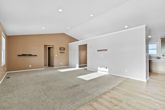 unfurnished room featuring light hardwood / wood-style flooring and vaulted ceiling