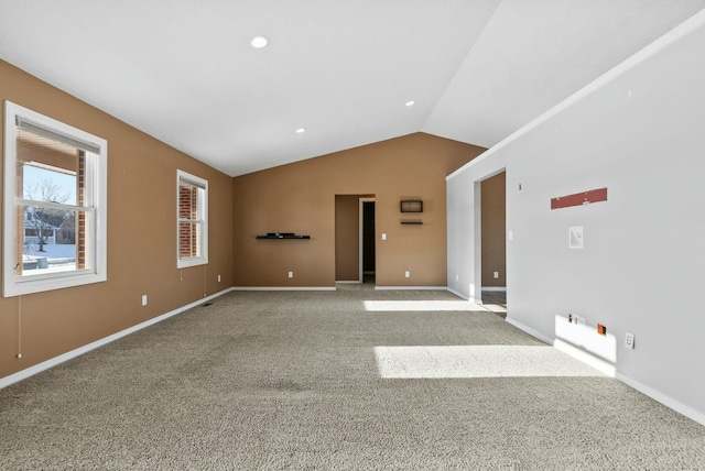 carpeted empty room featuring lofted ceiling