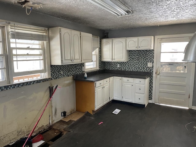 kitchen featuring white cabinetry, a healthy amount of sunlight, and decorative backsplash