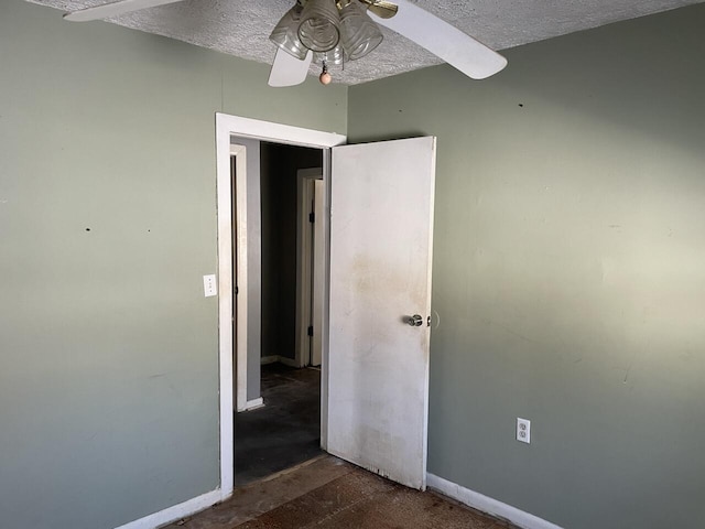 interior space with ceiling fan and a textured ceiling