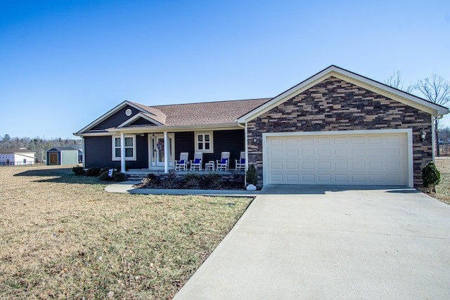 single story home with a garage, a front yard, and a porch