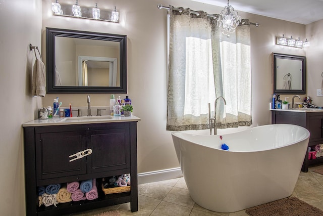 bathroom with vanity, a tub, and tile patterned floors