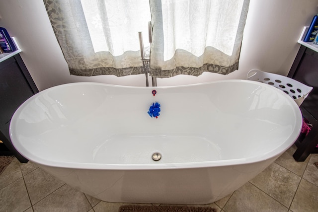 bathroom featuring tile patterned flooring and a washtub