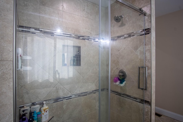 bathroom featuring a shower with door