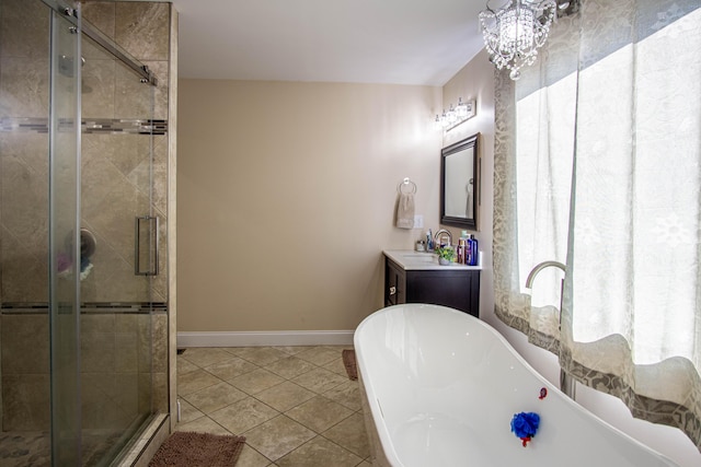 bathroom featuring tile patterned floors, shower with separate bathtub, a chandelier, and vanity