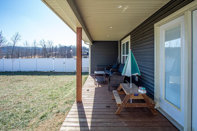 wooden terrace with a yard and an outdoor hangout area