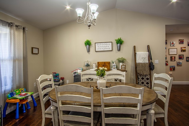 dining area featuring dark wood-type flooring, an inviting chandelier, and vaulted ceiling