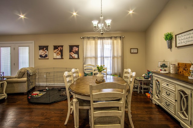 dining area with dark hardwood / wood-style flooring and a notable chandelier