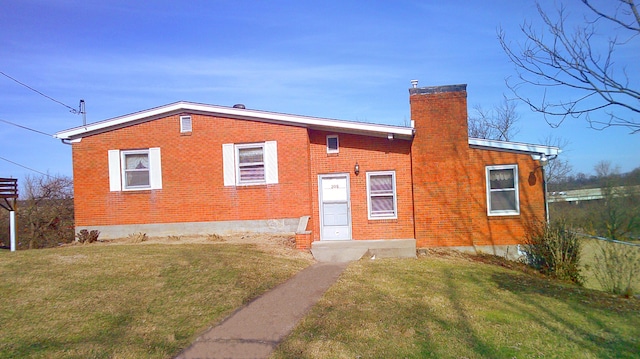 rear view of property with a yard