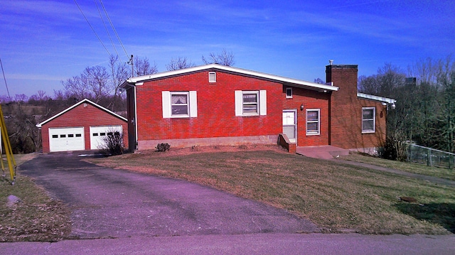 view of side of home featuring an outbuilding and a garage