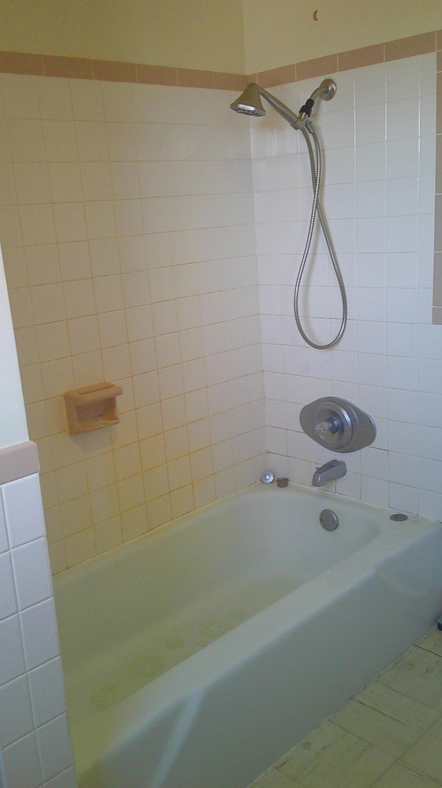 bathroom with tiled shower / bath combo and tile patterned floors