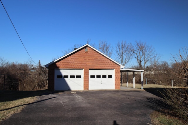 view of side of property featuring an outbuilding and a garage