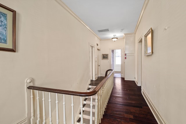 hall with ornamental molding and dark hardwood / wood-style floors