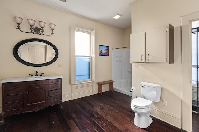 bathroom with wood-type flooring, toilet, vanity, and walk in shower