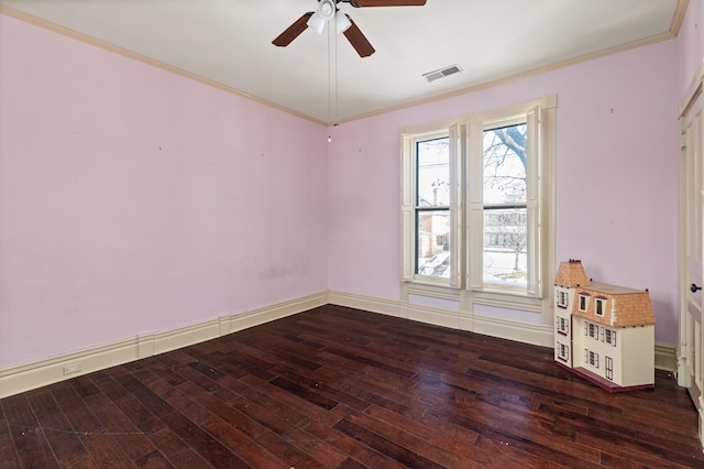 spare room with dark hardwood / wood-style flooring, crown molding, and ceiling fan