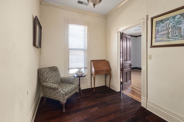 living area with ornamental molding, dark hardwood / wood-style floors, and a healthy amount of sunlight