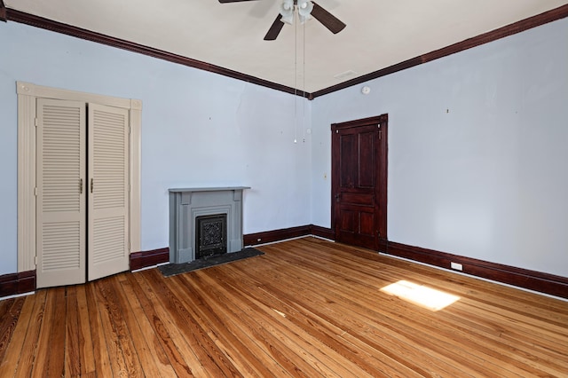 unfurnished living room featuring crown molding, ceiling fan, and wood-type flooring