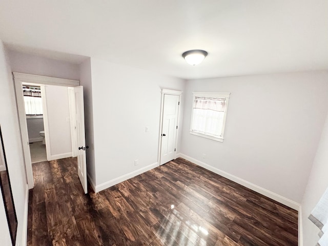 unfurnished bedroom featuring dark hardwood / wood-style floors