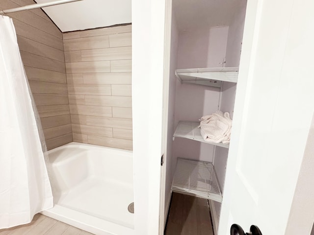 bathroom featuring hardwood / wood-style floors and walk in shower