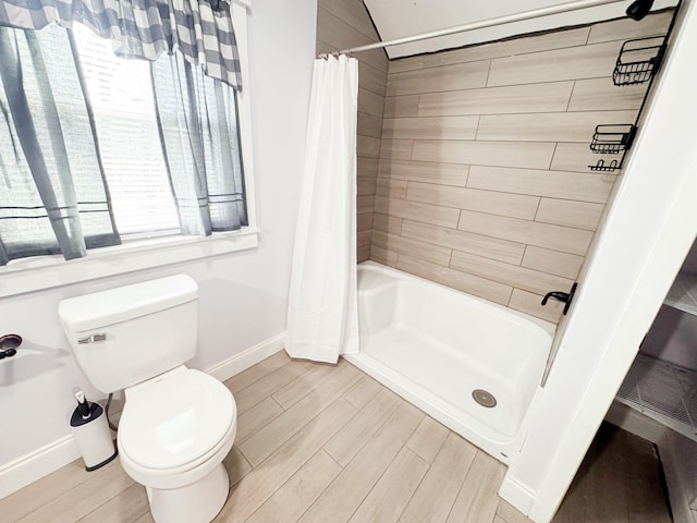 bathroom with curtained shower and toilet