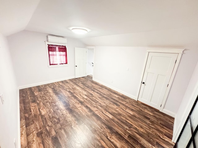 additional living space featuring lofted ceiling and dark hardwood / wood-style floors