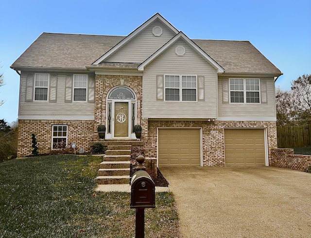 split foyer home featuring a garage and a front yard