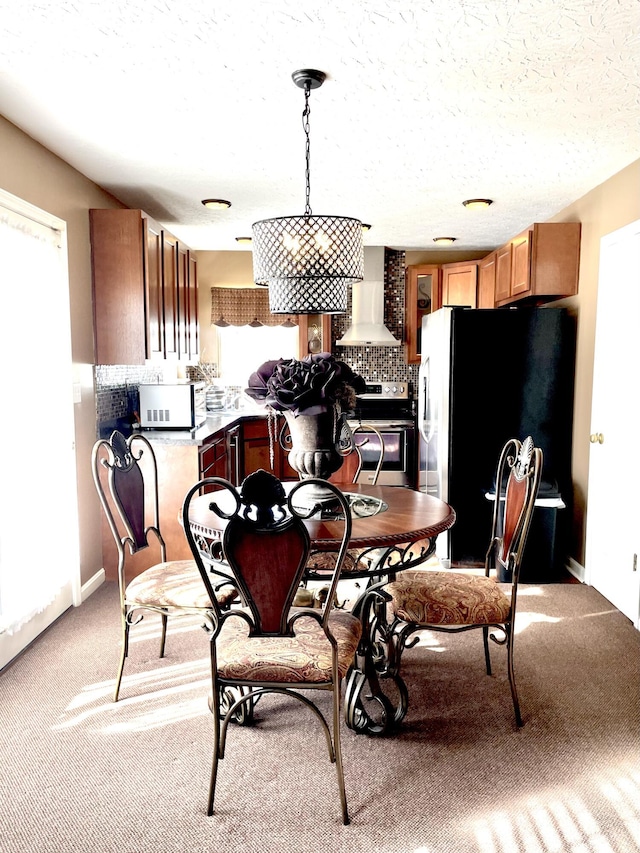 dining area with light carpet and a textured ceiling