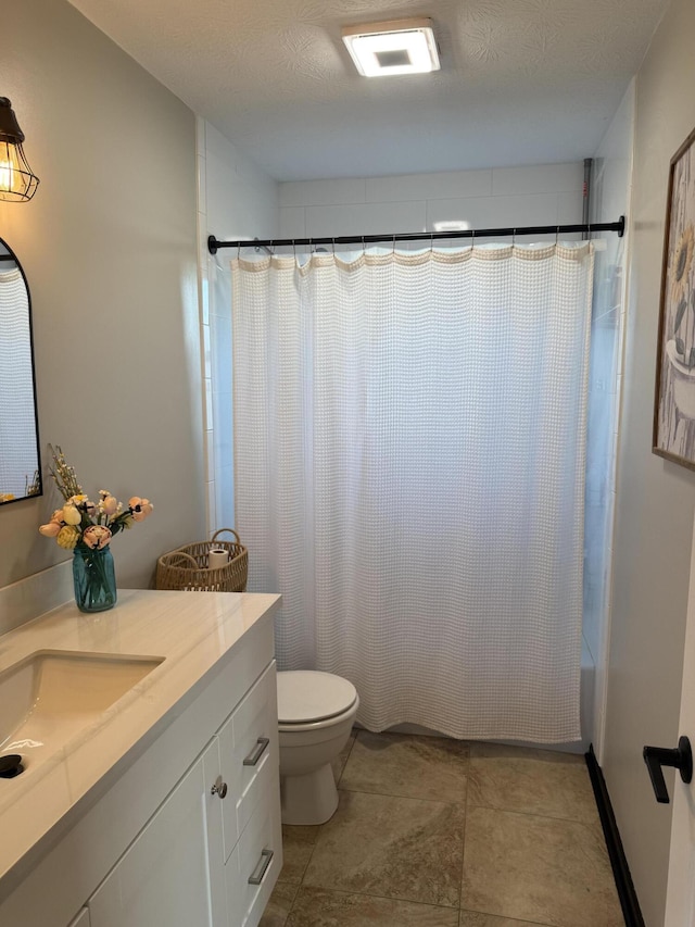 full bathroom with shower / tub combo with curtain, vanity, toilet, and a textured ceiling