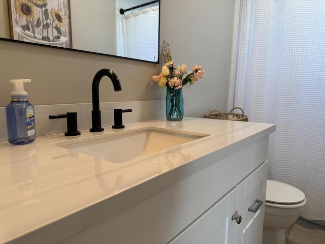 bathroom featuring vanity and toilet