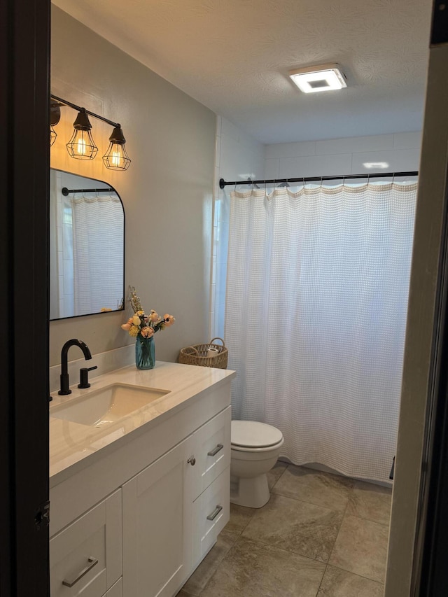 bathroom with walk in shower, vanity, toilet, and a textured ceiling