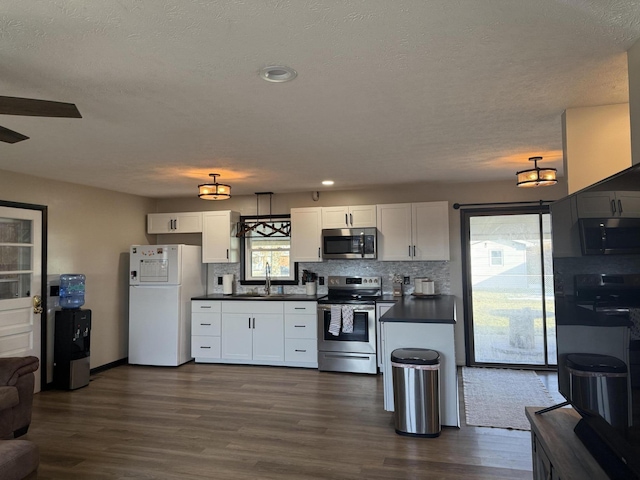 kitchen with white cabinetry, appliances with stainless steel finishes, sink, and a healthy amount of sunlight